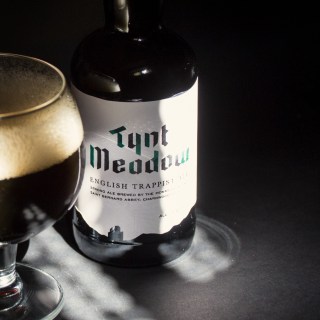 Today we feature the only English Trappist beer — Tynt Meadow from Mount St. Bernard Abbey.

Released in 2018, Tynt Meadow made history as the first English Trappist beer and one of the newest members of the Trappist family.

It’s brewed by monks in rural Leicestershire using English-grown ingredients — a beautiful fusion of Belgian tradition and British character.

Flavor Profile:
🍫 Dark chocolate
☕ Light roast & coffee notes
🍇 Dried fruit and fig
🌿 Subtle earthy hop balance
🔥 Warming, smooth finish

ABV: 7.4%

Fun Fact: The name “Tynt Meadow” comes from the land surrounding the abbey and references a medieval name for the area.

This is modern Trappist history in your glass.

🍺 Limited availability
🎁 Stickers up for grabs
🍻 Drink with intention
